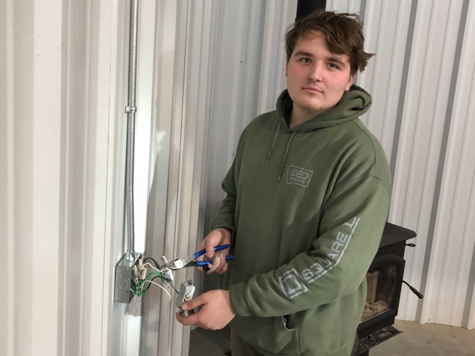 Marrow Electric technician working on an electrical switch