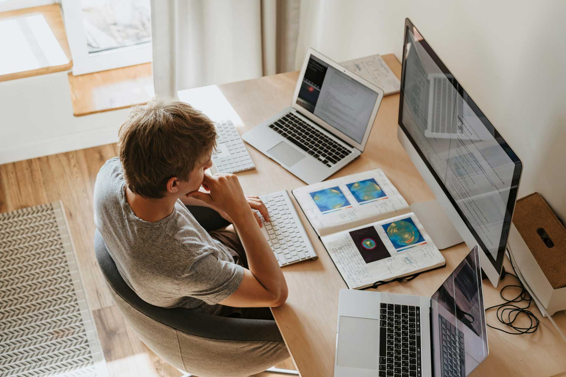 man at home office desk working on computer