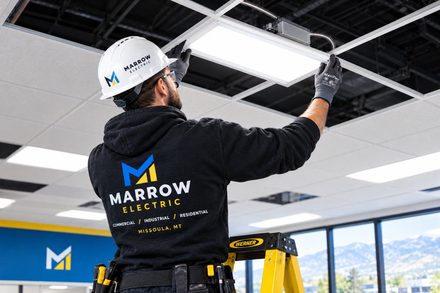 Marrow Electric technician installing commercial LED lighting in Missoula Electrician in Stevensville, MT